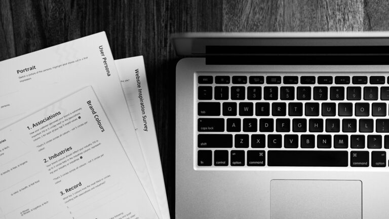 Professional business writing workspace with laptop and notes, representing clear communication, structured thinking, and effective business writing.