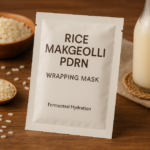 Rice Makgeolli PDRN wrapping mask displayed with rice grains and fermented rice drink on a wooden surface, representing Korean fermented skincare and hydration care.