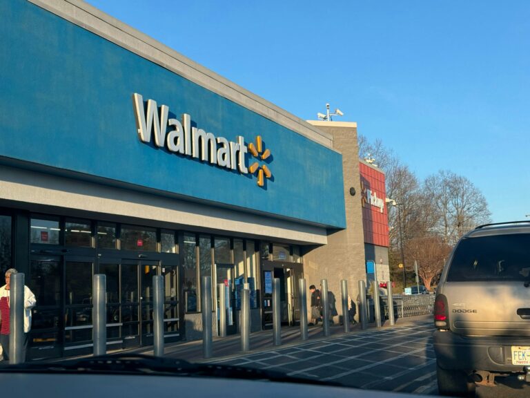 Walmart store exterior with headline about rising profits and their impact on the U.S. economy and local communities.