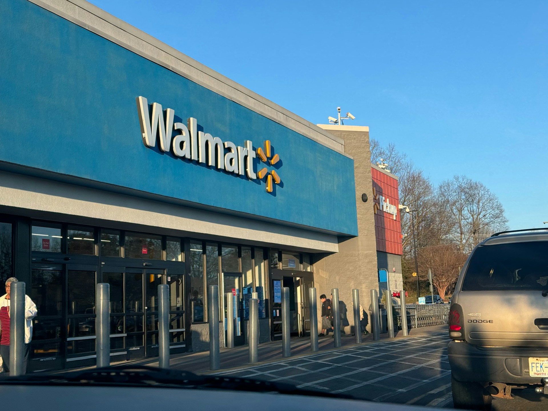 Walmart store exterior with headline about rising profits and their impact on the U.S. economy and local communities.