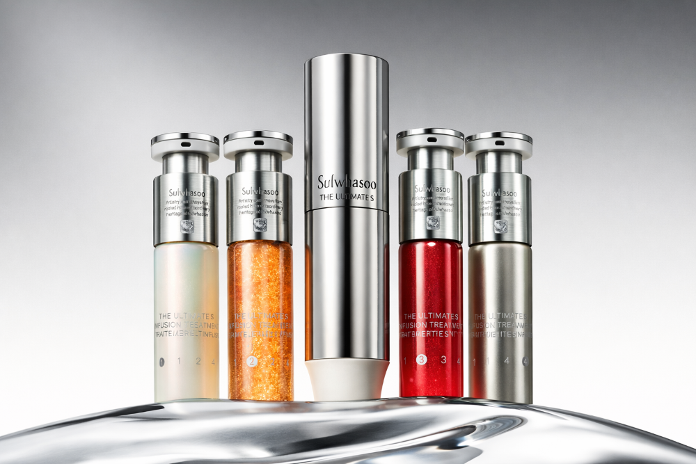 Sulwhasoo Jinseol Infusion Treatment skincare set featuring multiple serum vials and a central treatment bottle in a luxury studio setting.